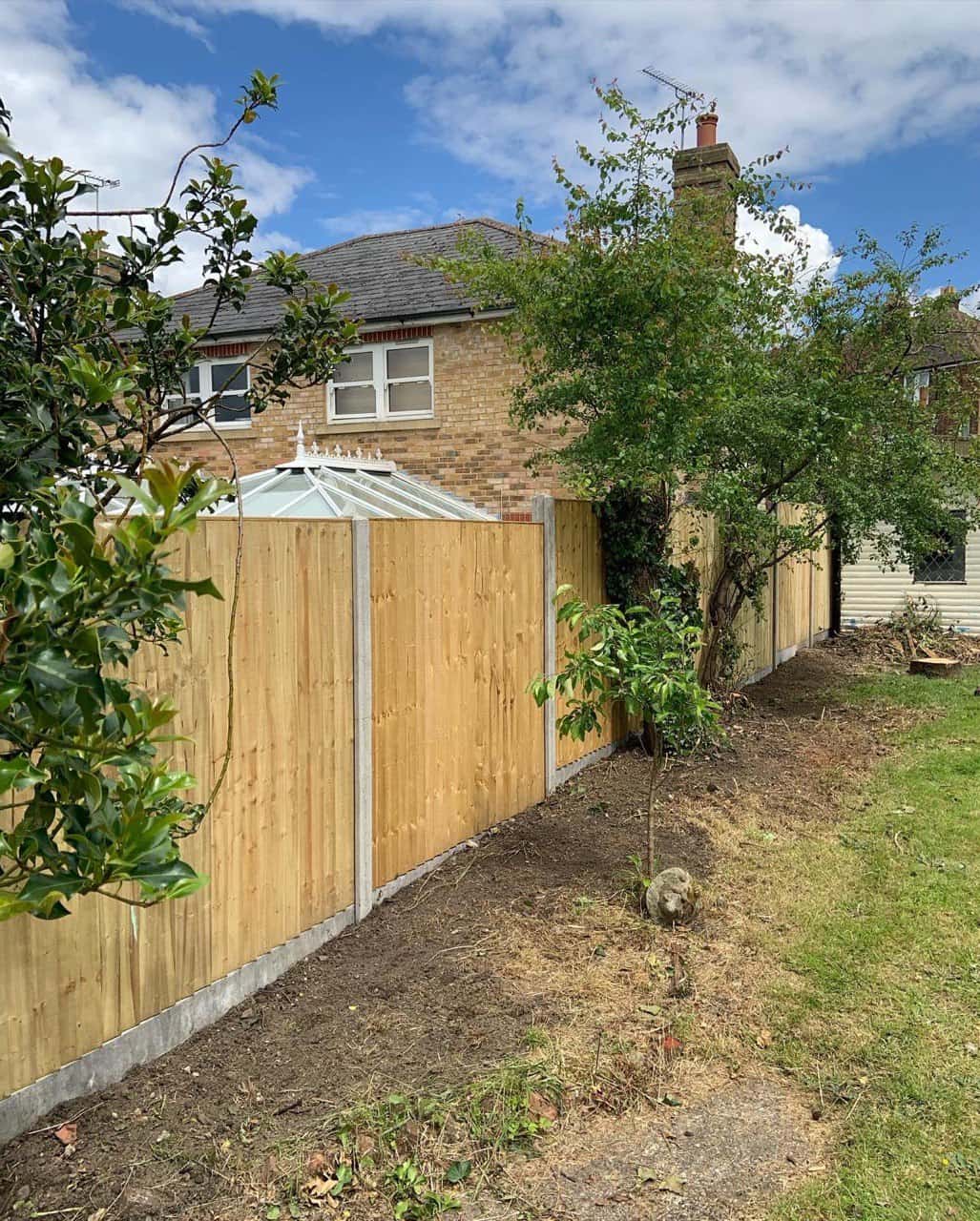 This is a photo of fence panels installed in a residential garden using concrete posts and gravel boards. Installed by Fast Fix Fencing Paddock Wood